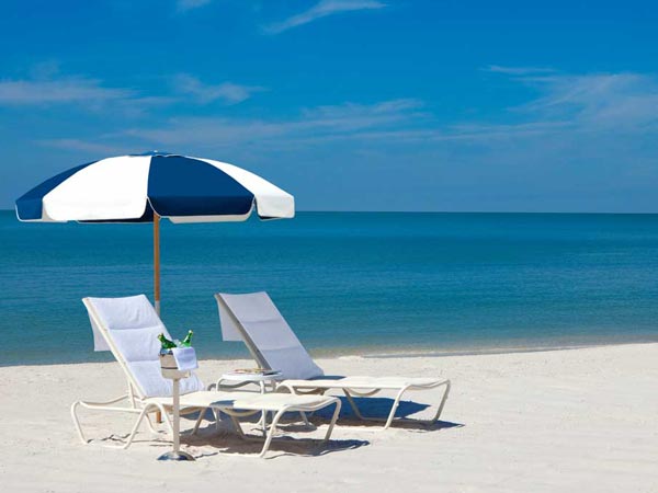 Lounge chairs, umbrella, and drinks at La Playa Beach and Golf Resort in Naples, FL